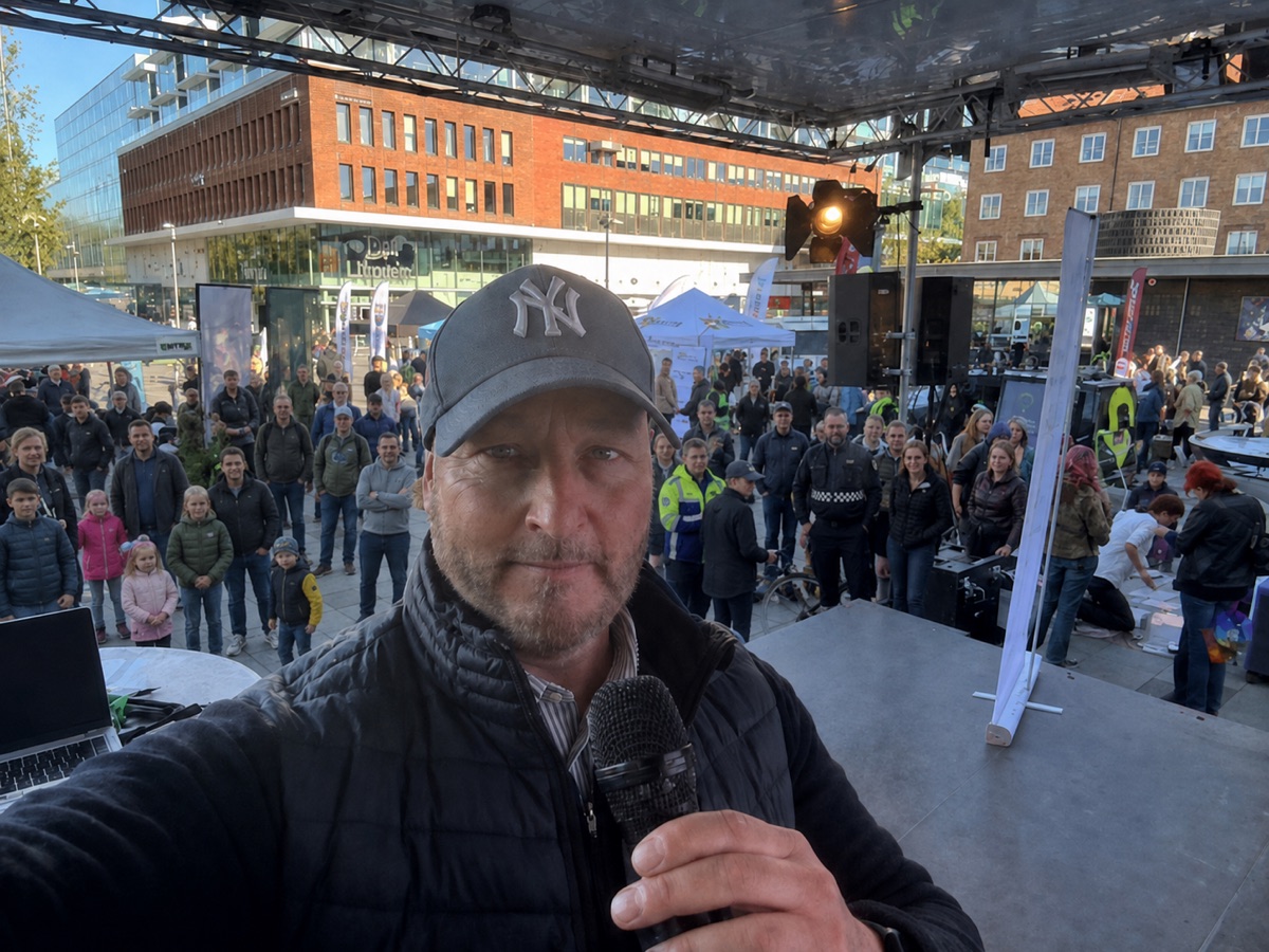AI-bearbetad stämningsbild: Daniel med mikrofon på Rådhustorget, med publik framför scenen.
